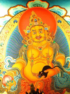 Jambhala, Zenginlik Tanrısı ve Mücevher Ailesi 'nin uygun bir üyesidir (bkz. Ratnasambhava). Hindu mitolojisinde Jambhala Kubera olarak bilinir. Jambhala 'nın da Avalokitesvara veya Chenrezig, Bodhisattva' nın bir ürünü olduğuna inanılır..
