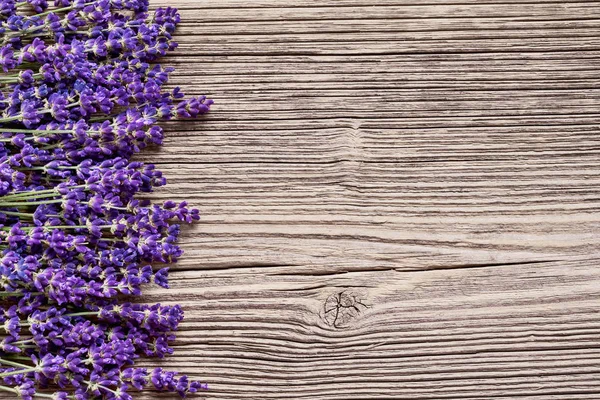 Lavender flowers on wooden background. Top view, copy space. — Stock Fotó