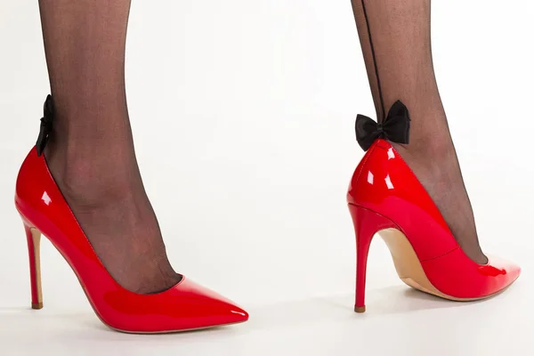 Sexy legs in red high-heeled shoes. — Stock Photo, Image