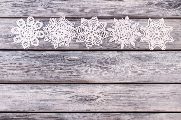 Collection of snowflakes on a wooden background. — Stock Photo, Image