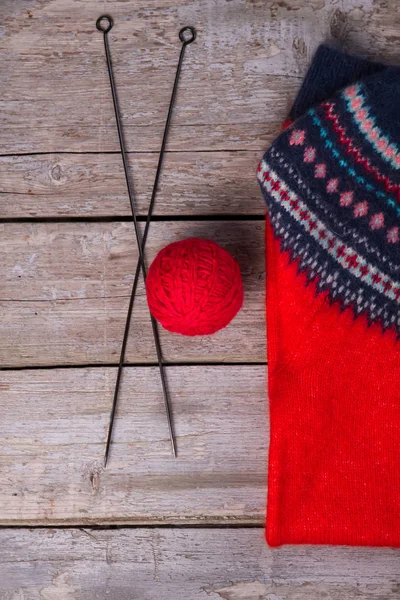 Sweater and yarn with knitting needles. Winter still life. — Stock Photo, Image