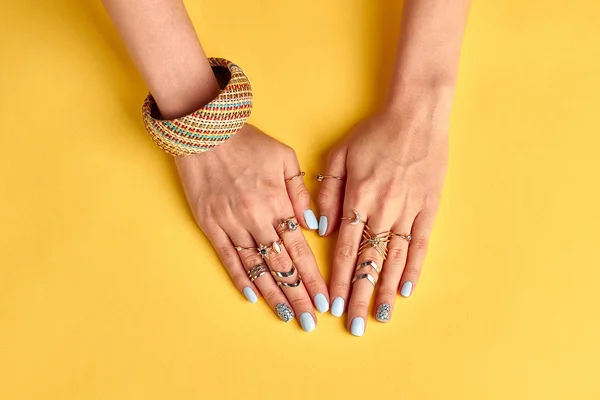 Beautiful female nails on a bright yellow background. — Stock Photo, Image