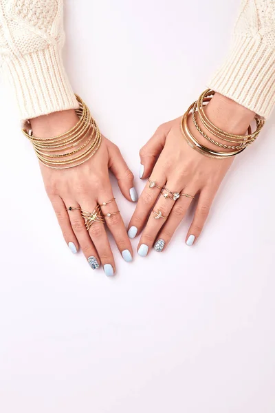 Many different jewelery bracelets and rings on hands. — Stock Photo, Image