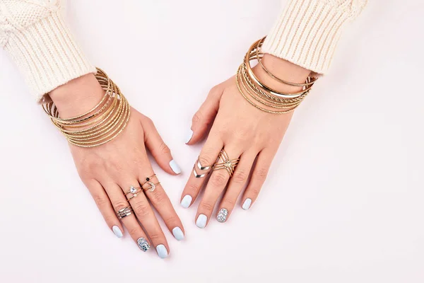 Gold and silver jewelry on women's hands. — Stock Photo, Image