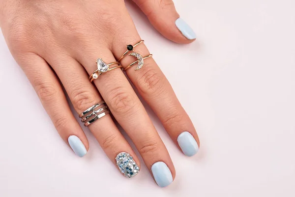 Beautiful manicure with jewelry close up.