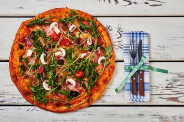 Sıcak pizza ve çatal bıçak takımı.