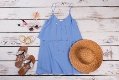 Summer women clothing, wooden background. clipart