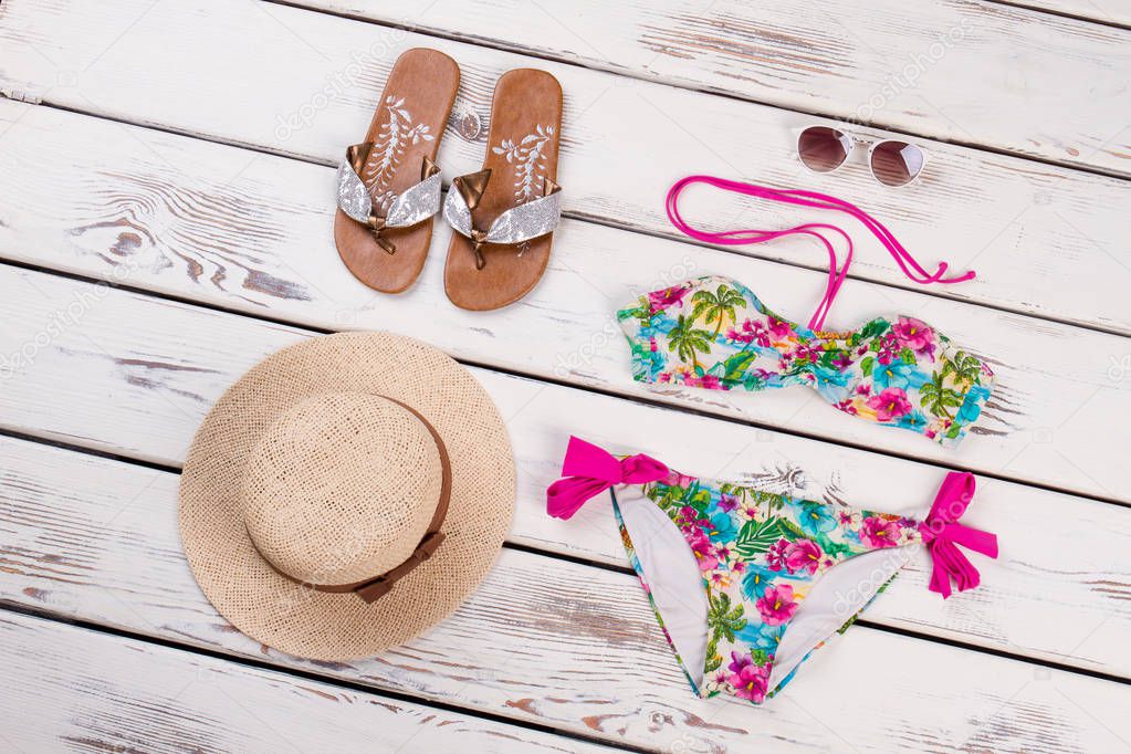 Summer beach accessories, wooden background.