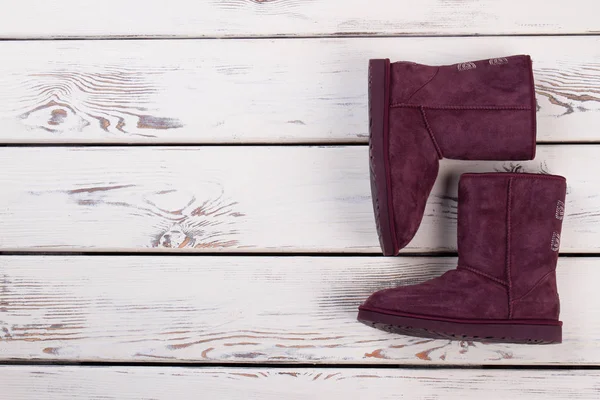 Purple boots on wooden background — Stock Photo, Image