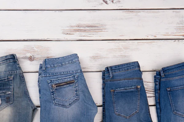 Pairs of jeans on showcase — Stock Photo, Image