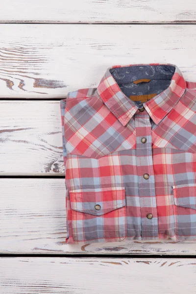 Folded flannel plaid shirt