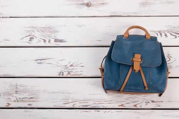 Leather backpack on wooden background