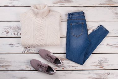 Beyaz jumper, kot pantolon ve spor ayakkabı