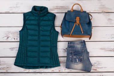 Kapitone yelek, kot pantolon ve sırt çantası