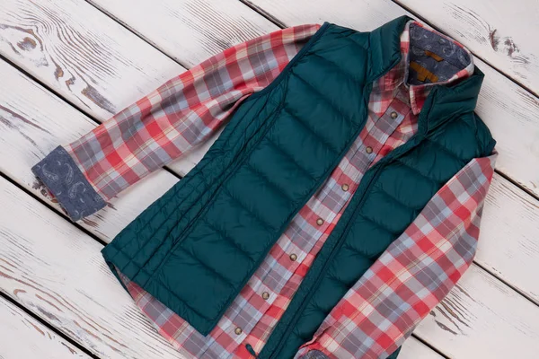 Down vest and flannel shirt