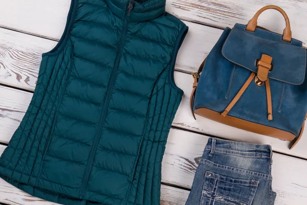 Quilted down vest and jeans