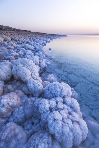 Salt on the shore of the Dead Sea. Jordan sunset landscape