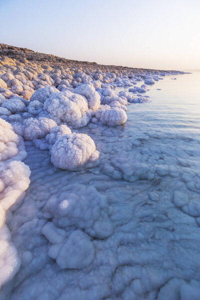 Salt on the shore of the Dead Sea. Jordan sunset landscape