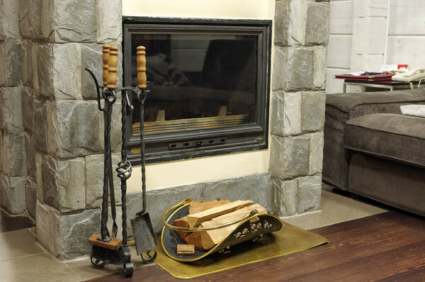 Firewood burns in the fireplace creating warmth and homeliness