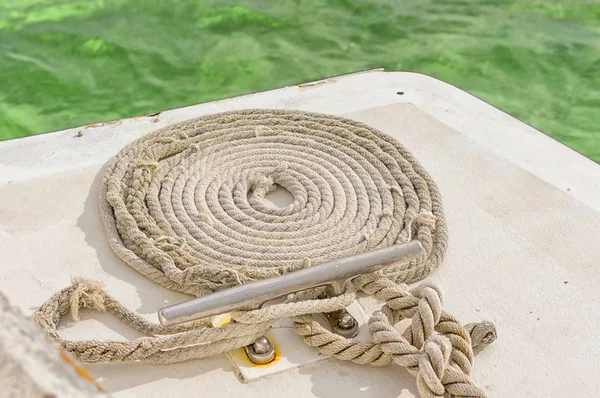 The rope rope is neatly folded on the ships deck