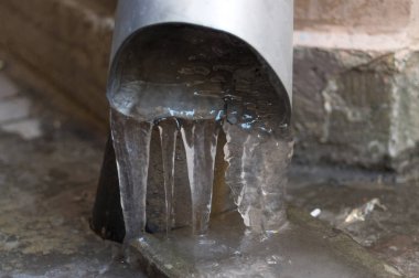 The frozen water from the drainage pipe clipart