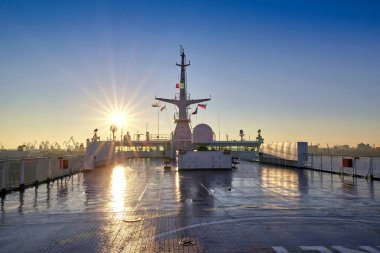 Deck of a cruise liner on the background of the morning rising s