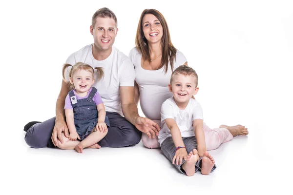 Happy family with two kids on studio white background — Stock Photo, Image