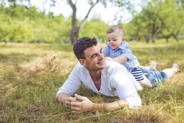 Beautiful father little toddler son on the meadow. — Stock Photo, Image