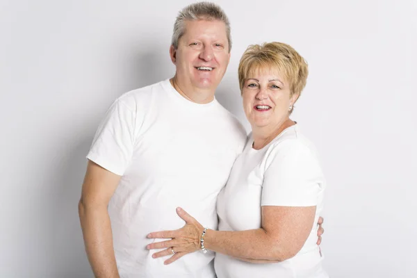 Happy smiling senior couple standing together on white background — Stock Photo, Image