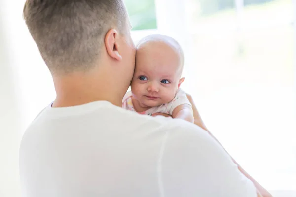 Young father holding her newborn child on the baby room — Stock Photo, Image