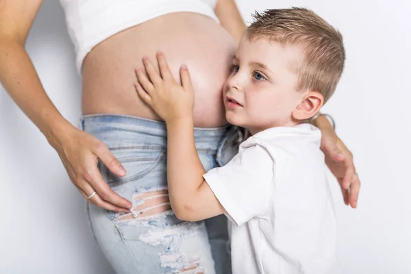 Young boy with the pregnant woman isolated on white background — Stock Photo, Image