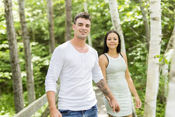 Young couple embraces in a summer garden — Stock Photo, Image