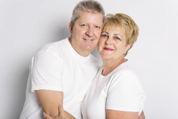 Happy smiling senior couple standing together on white background — Stock Photo, Image