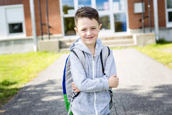 Student outside school standing smiling — Stock Photo, Image