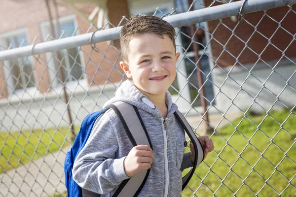 Student outside school standing smiling — Stock Photo, Image