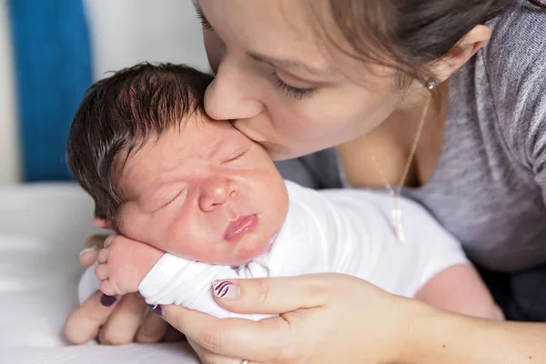 Mãe feliz e bebê deitado na cama em casa — Fotografia de Stock