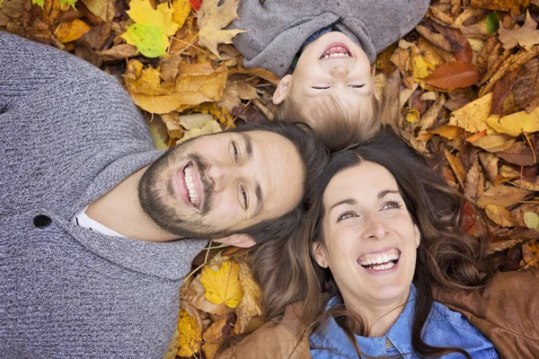 Happy family relaxing outdoors In autumn park — Stock Photo, Image