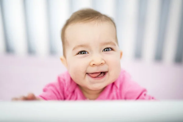 Infant baby resting and playing in his little baby bed — Stock Photo, Image