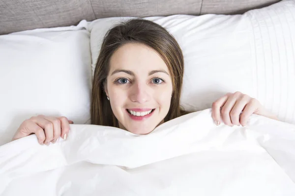 Young sleeping woman in bedroom at home wearing in white — Stock Photo, Image