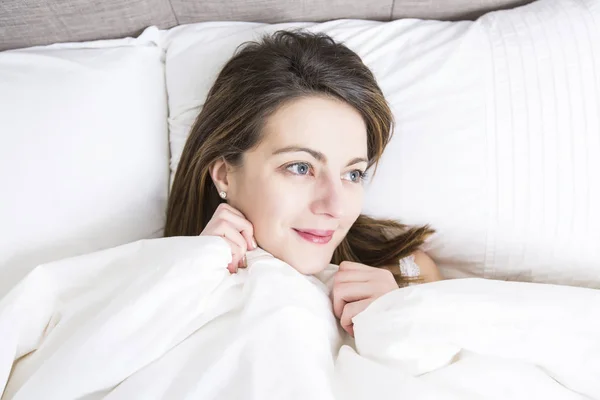 Young sleeping woman in bedroom at home wearing in white — Stock Photo, Image