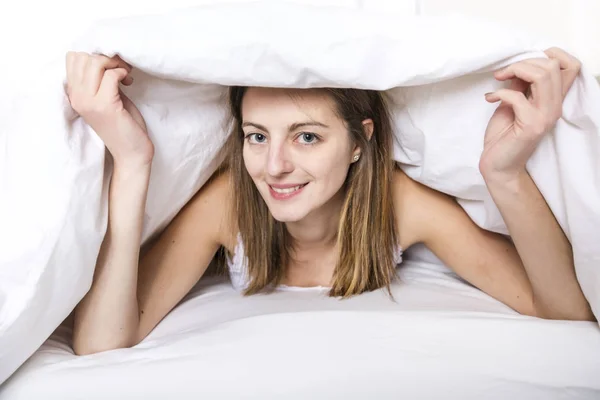 Young sleeping woman in bedroom at home wearing in white — Stock Photo, Image