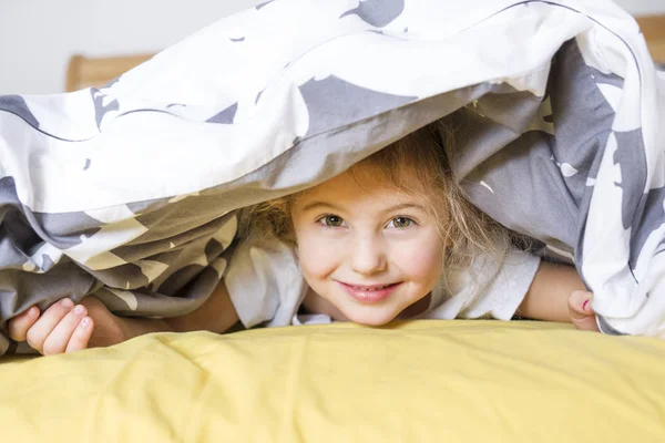 Adorable little girl wake up in her bed — Stock Photo, Image