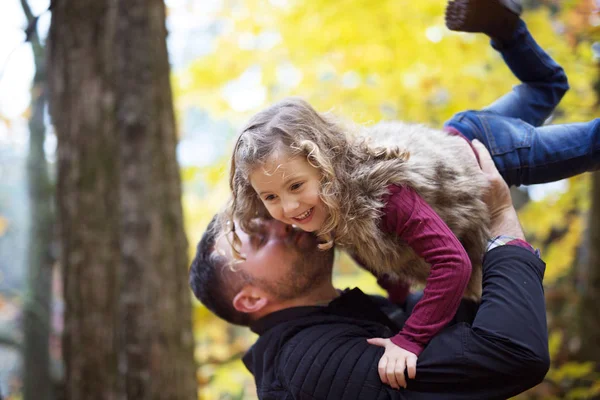 Little adorable girl with happy father in autumn park outdoors — Stock Photo, Image