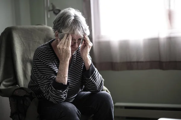 Worried senior woman at home felling very bad — Stock Photo, Image