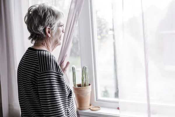 Worried senior woman at home felling very bad — Stock Photo, Image