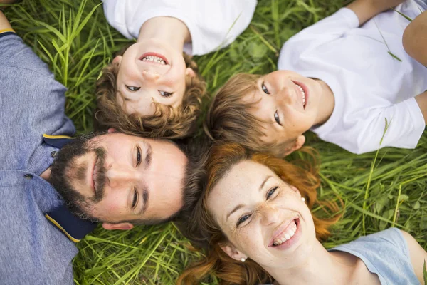 Happy family in the meadow — Stock Photo, Image