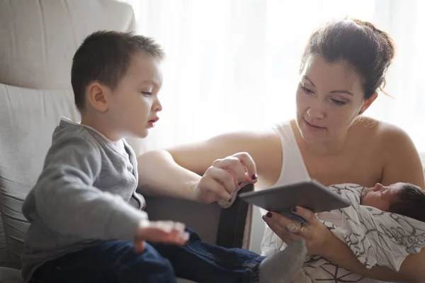 Mãe e filho usando tablet digital em casa — Fotografia de Stock