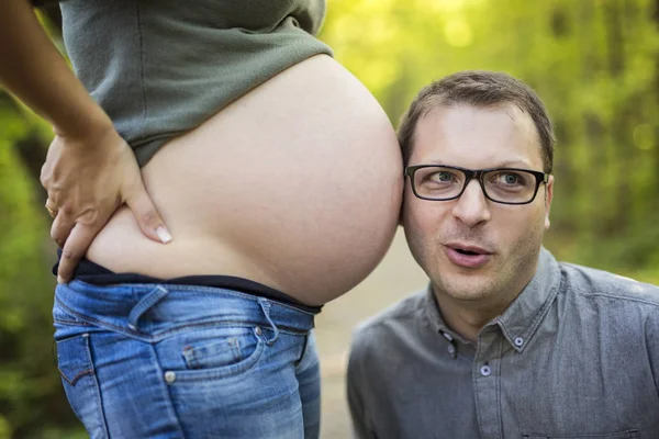 Family together in the autumn park. Woman is pregnant — Stock Photo, Image