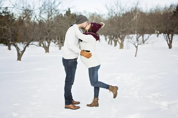 Embarazada pareja divertirse en invierno naturaleza — Foto de Stock