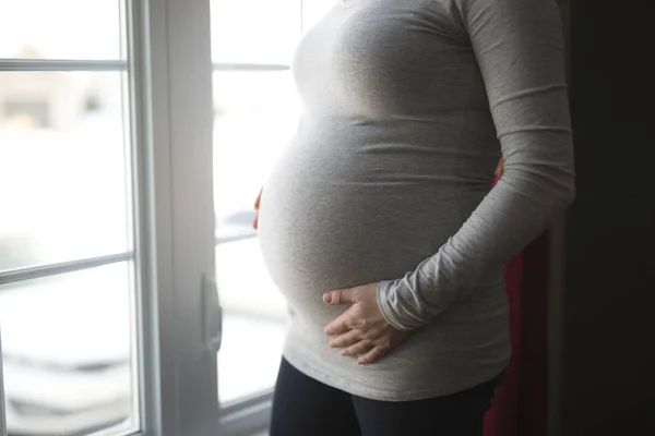 Young pregnant woman close to the window — Stock Photo, Image